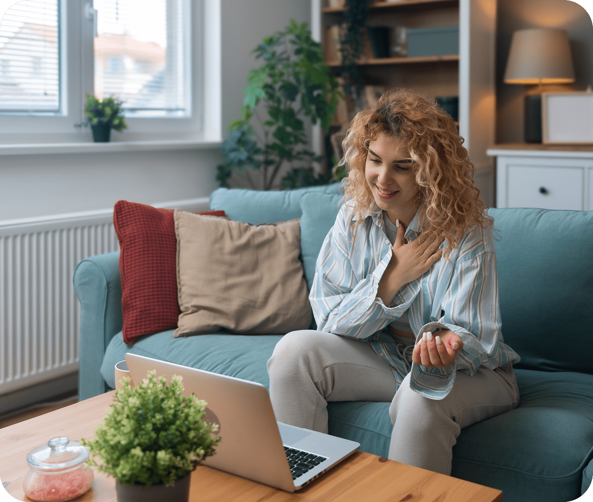 Woman video chatting on laptop at home.